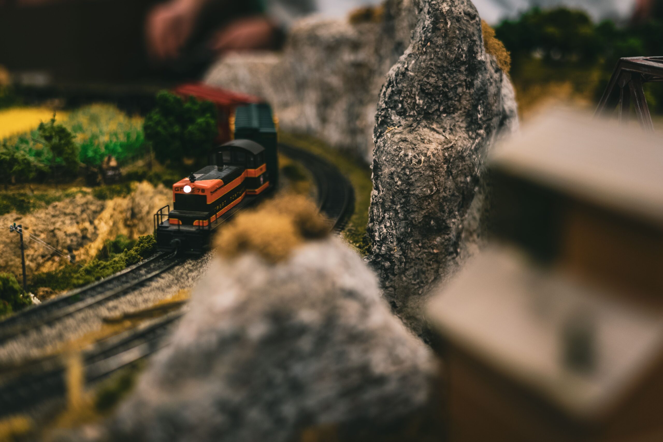 Model train travelling through a miniature railway layout